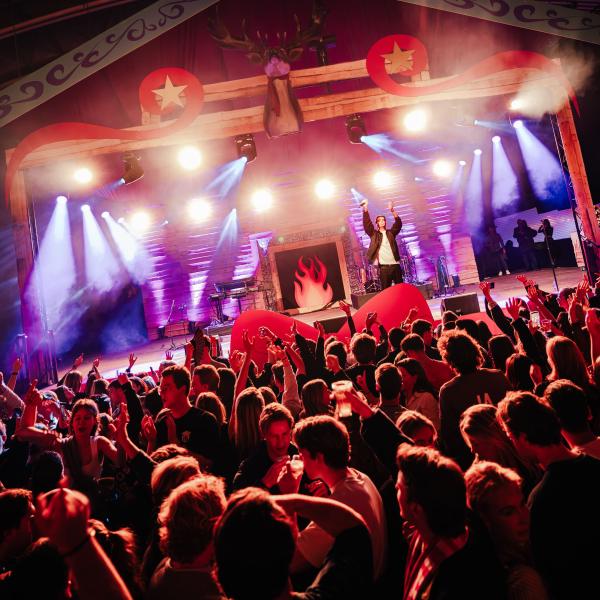 Music stage with a crowd in red light